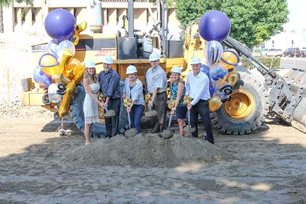 Far West principals with shovels of dirt at ground-breaking ceremony.
