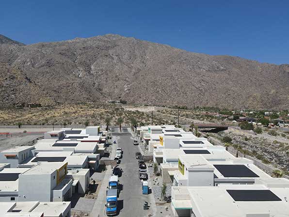 elan aerial view of street with single family homes.